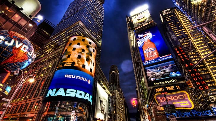 Bright digital billboards illuminating Times Square at night in New York City.